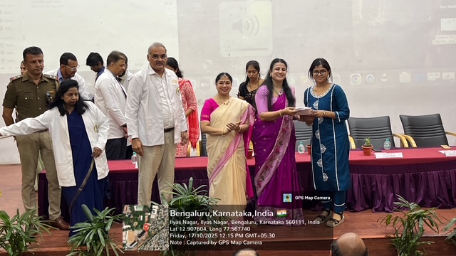 Dignitaries on stage presenting white coats