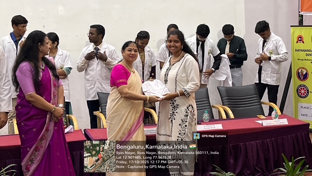 Guest of Honour Mrs. Rekha Ramchandran presenting a white coat