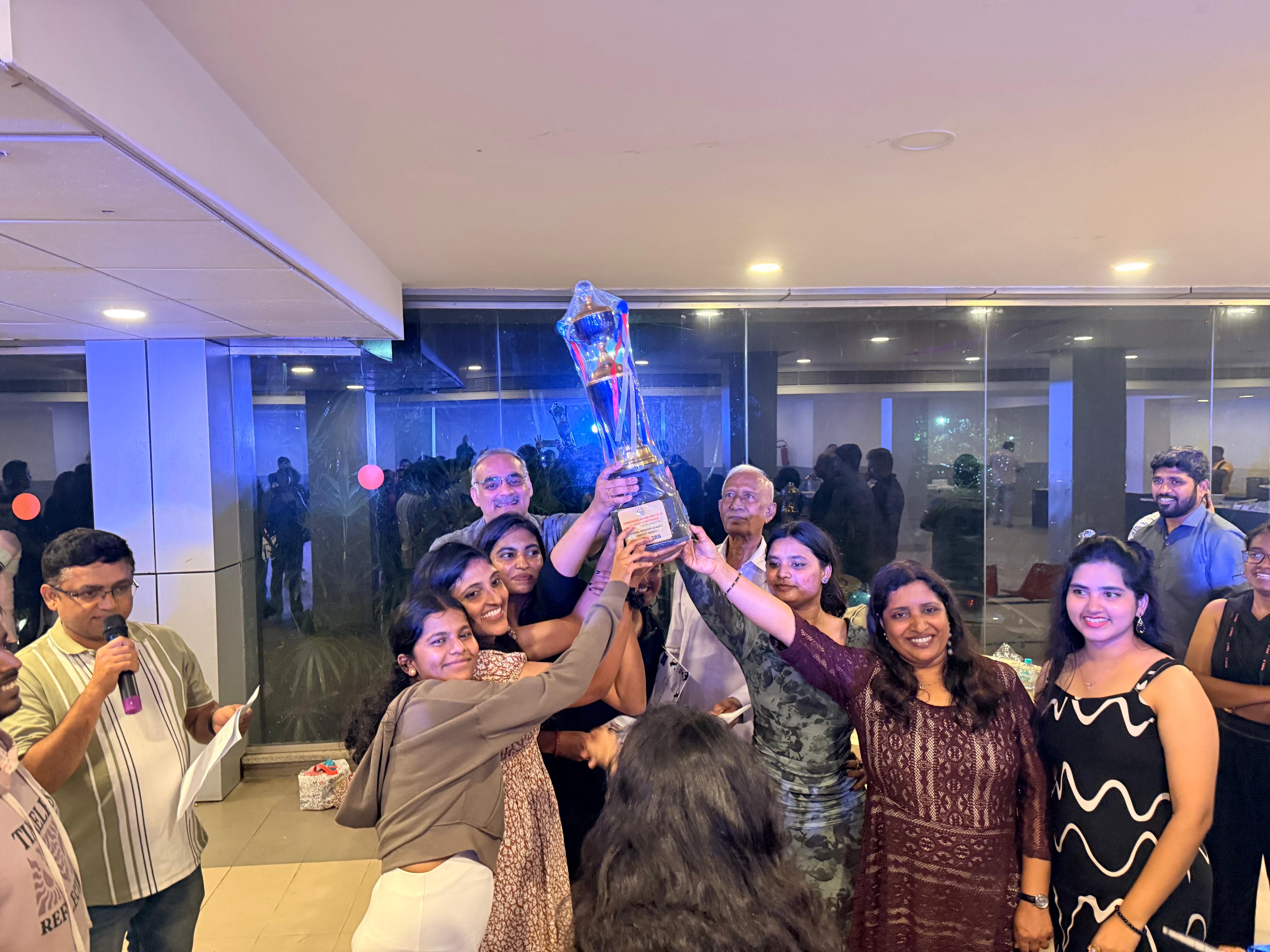 Men's team celebrating with trophy