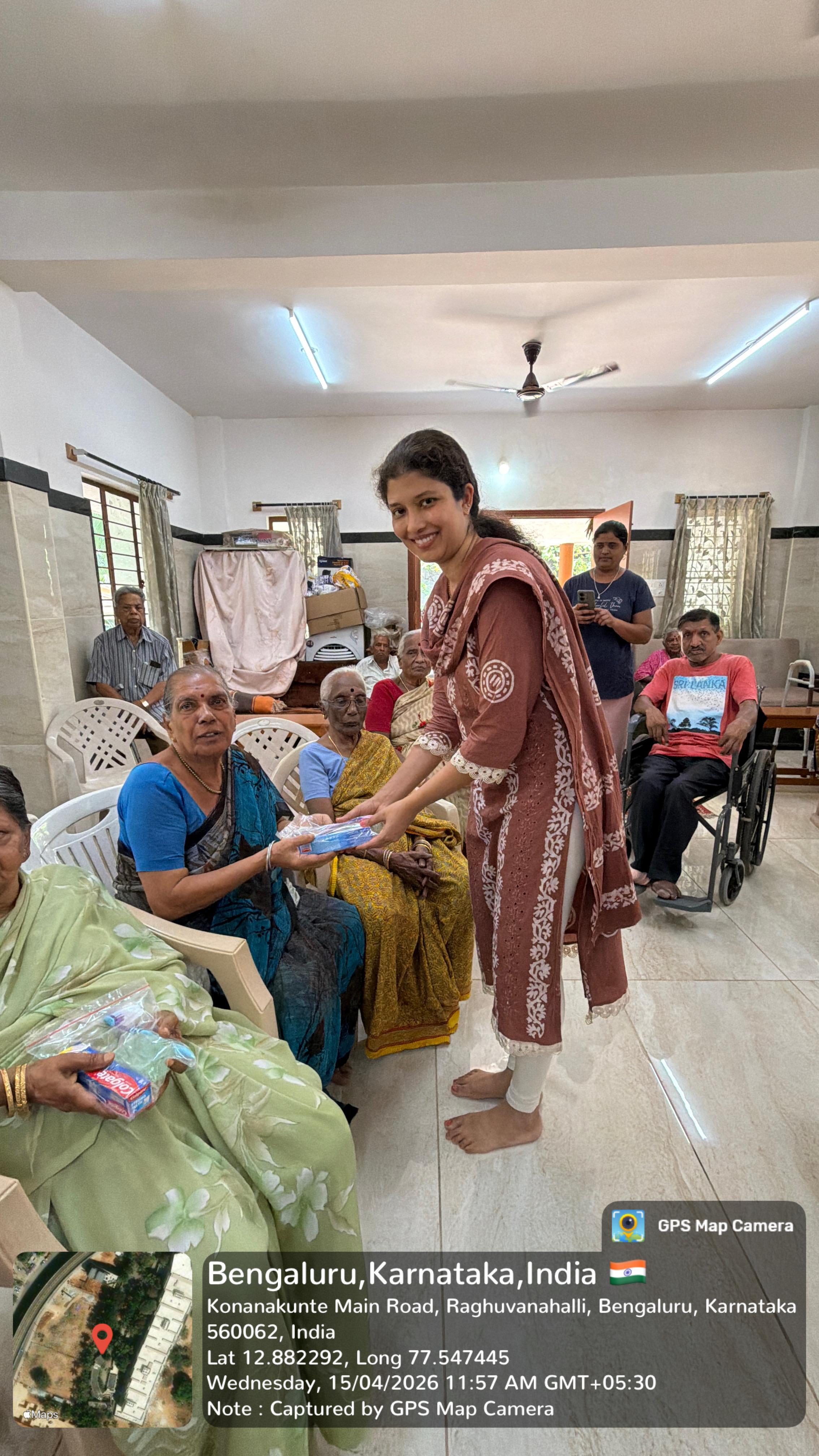 Volunteer distributing hygiene kits to an elderly woman resident