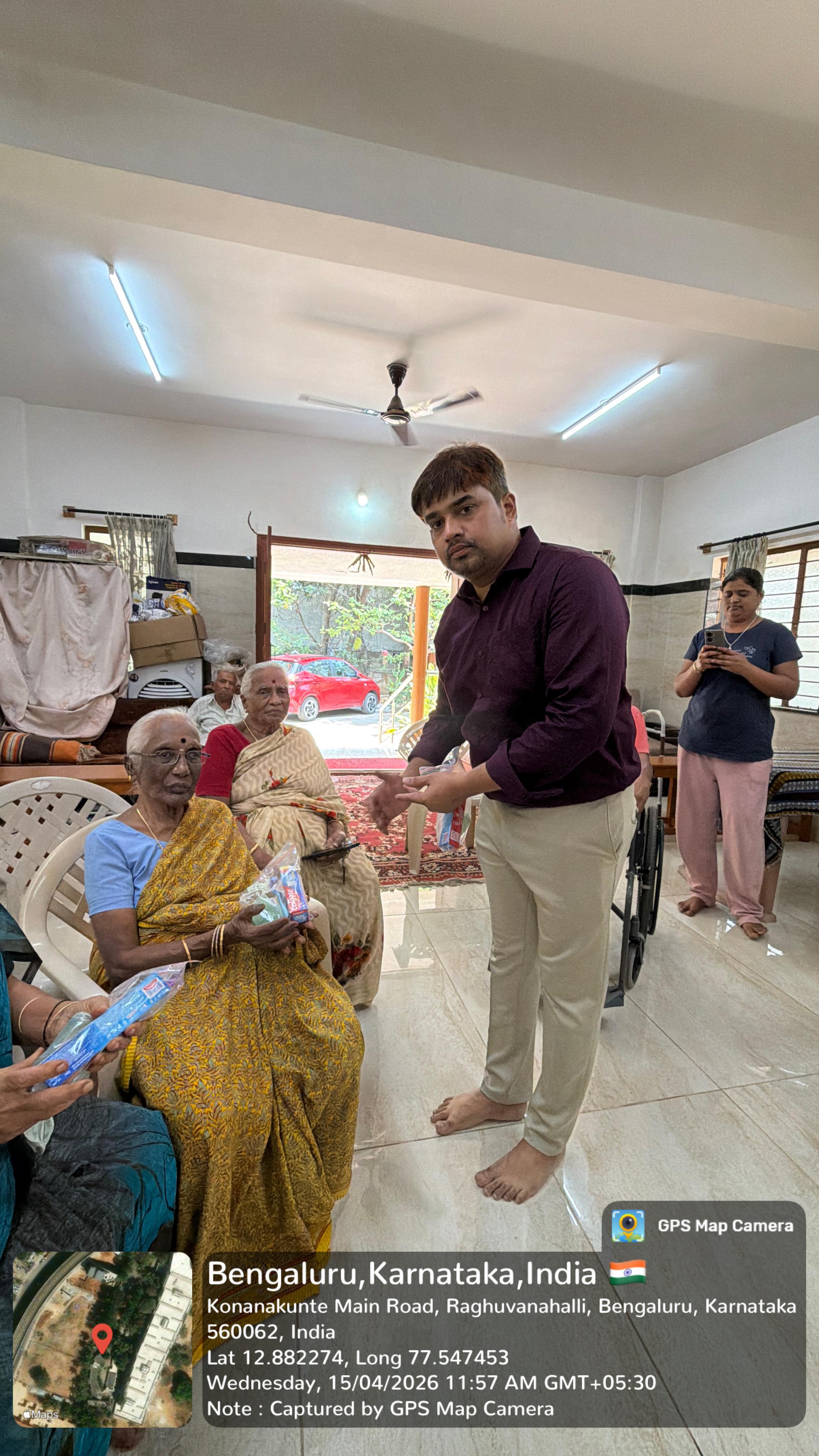 Dental team members with donated items (wheelchair, fan) and residents