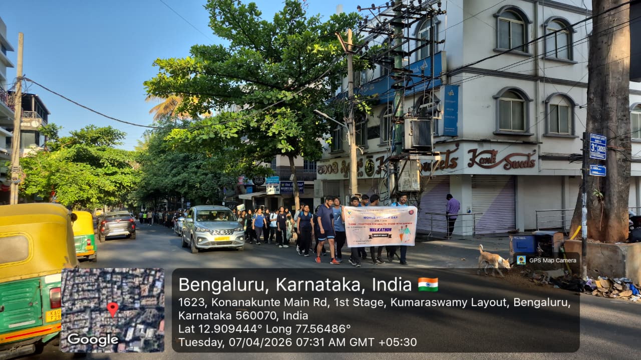 Another group photo of walkathon participants with the event banner.