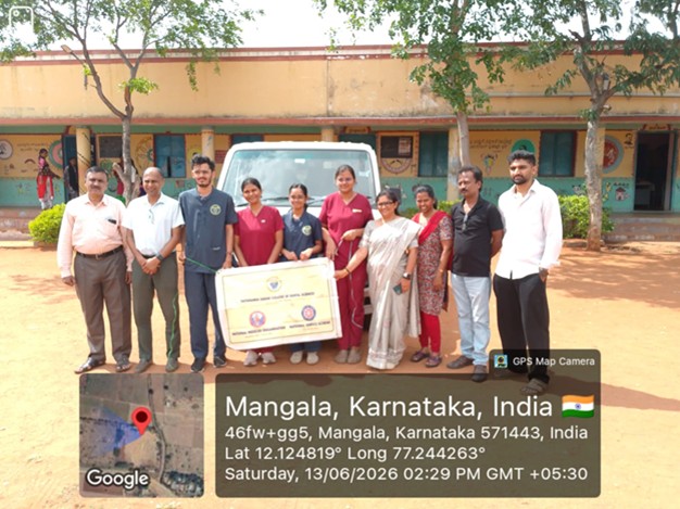 Dental team member demonstrating oral hygiene during health education at Chamarajanagar